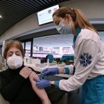 Una sanitaria vacuna a una mujer en el estadio Wanda Metropolitano en Madrid.