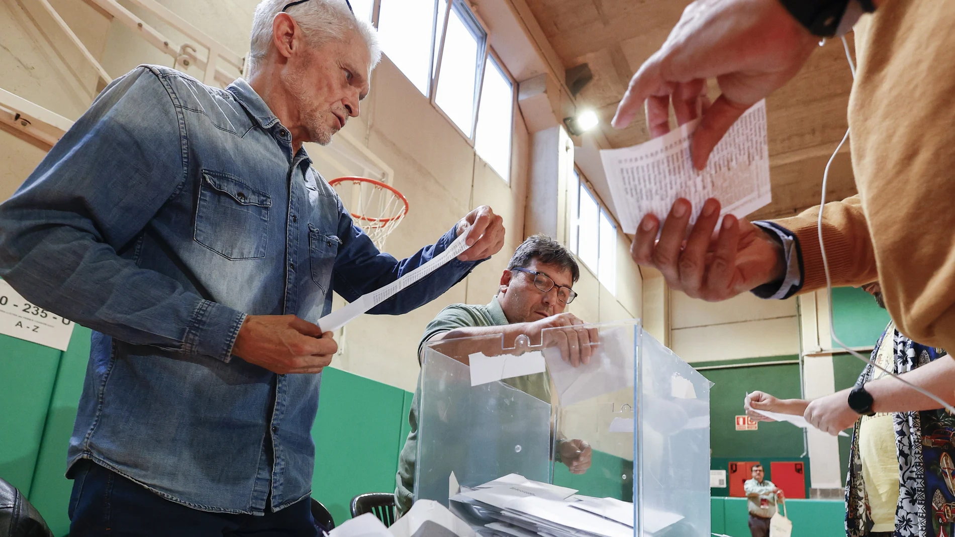 Los miembros de una mesa electoral proceden a la apertura de las urnas para el recuento de votos, tras el cierre de los colegios electorales este domingo 12 mayo en Barcelona.
