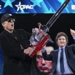 Elon Musk, left, receives a chainsaw from Argentina's President Javier Milei as they arrive speaks at the Conservative Political Action Conference, CPAC, at the Gaylord National Resort & Convention Center, Thursday, Feb. 20, 2025, in Oxon Hill, Md. 