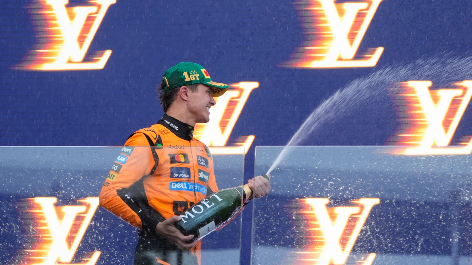 McLaren driver Lando Norris of Britain celebrates on the podium after winning the Australian Formula One Grand Prix at Albert Park, in Melbourne, Australia, Sunday, March 16, 2025. (AP Photo/Asanka Brendon Ratnayake)