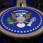 President Donald Trump, left, and first lady Melania Trump walk to the stage to dance at the Commander in Chief Ball, Monday, Jan. 20, 2025, in Washington. 